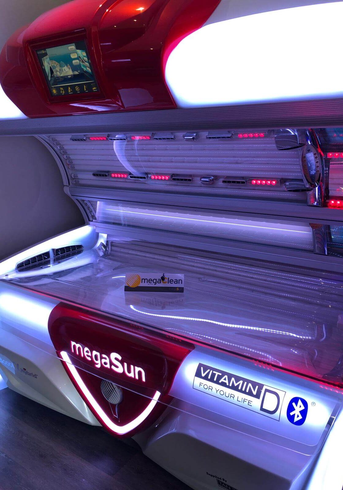 A tanning bed with the lights on and a red light.