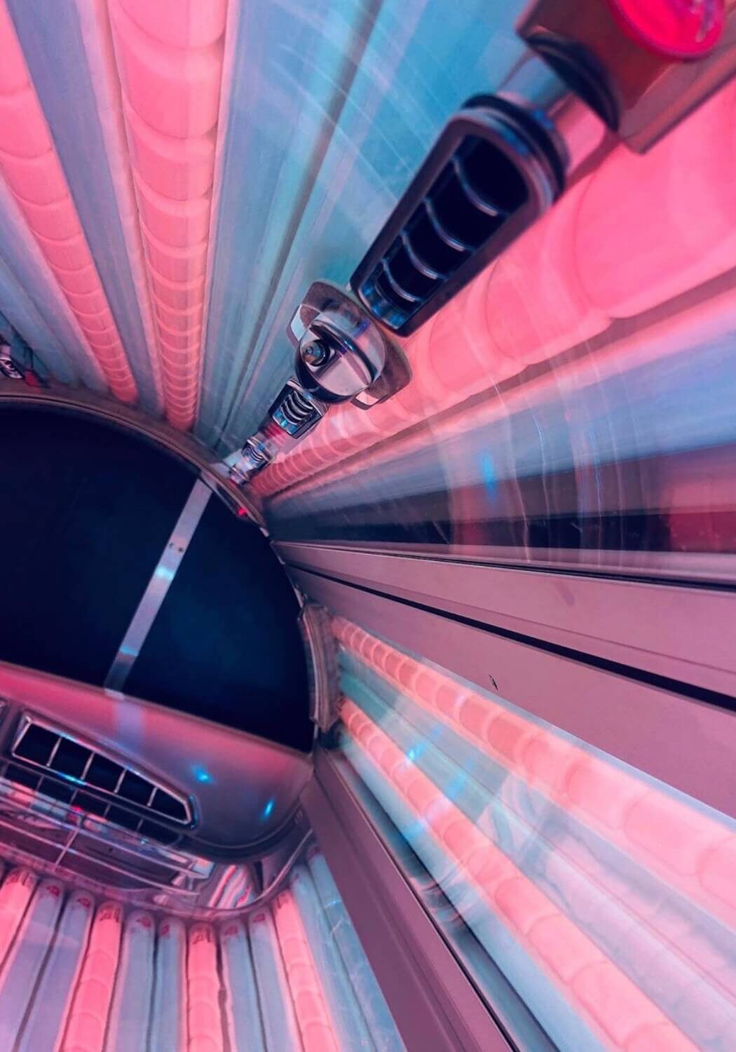 A car driving down the street in a tunnel.