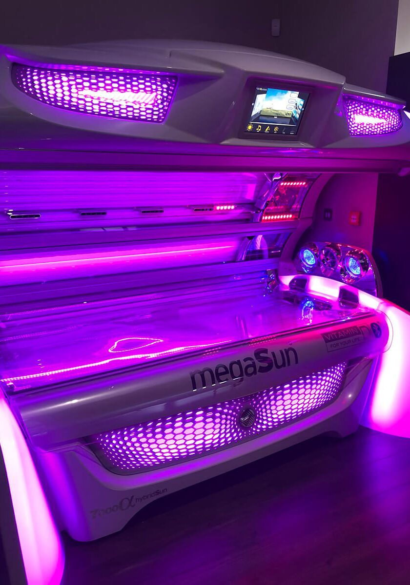 A tanning bed with purple lights on it.